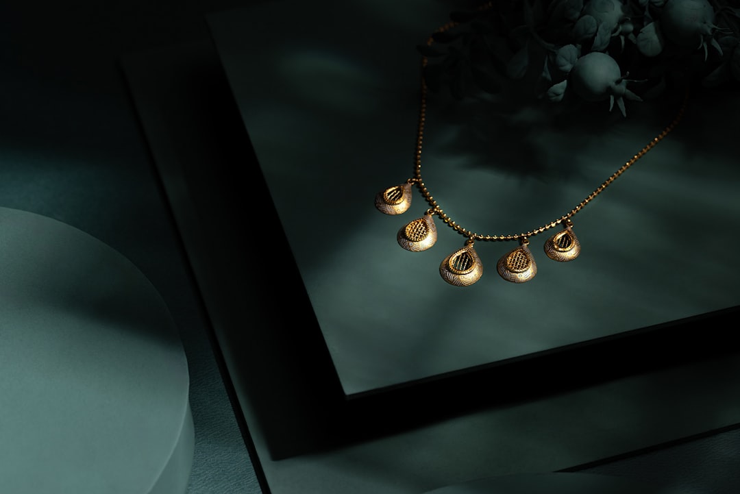 A picture of a necklace on a table - Photo by NEXARO STUDIO on Unsplash